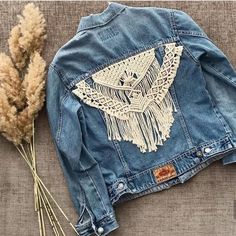 a denim jacket with crochet on the back