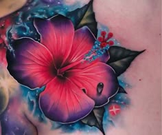 a woman's chest with a flower tattoo on it