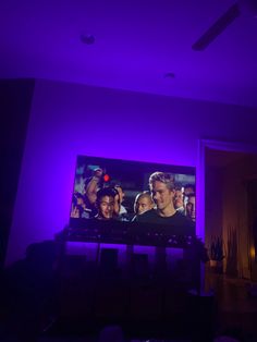 a purple light is shining on a television screen