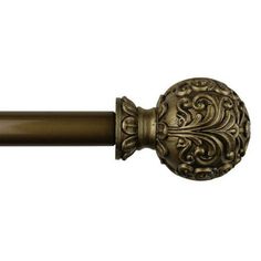 an antique style curtain rod with a decorative design on the top and bottom, in bronze