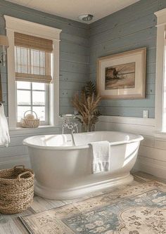 a white bath tub sitting in a bathroom next to two windows