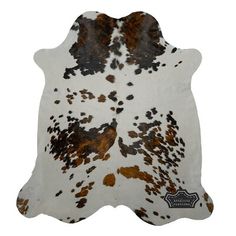 a cowhide rug with brown and white spots on it's back, in front of a white background