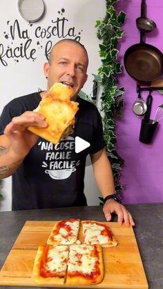 a man is eating some pizza on a cutting board