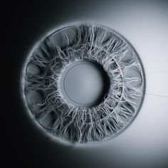 an eyeball that looks like it is made out of plastic and has been photographed in the dark