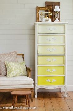 an old dresser is painted yellow and white with some green accents on the bottom drawer