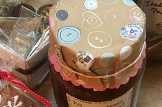 a bottle of wine sitting on top of a table next to some cookies and candies