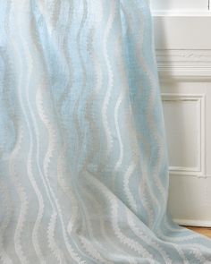 a blue and white curtain with wavy lines on it