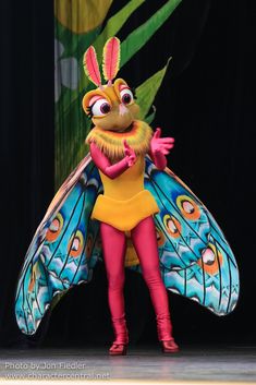 a woman dressed as a butterfly on stage