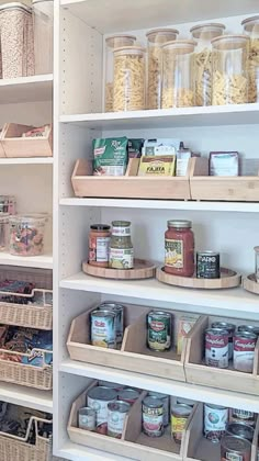 an organized pantry filled with lots of food and storage bins on shelving units