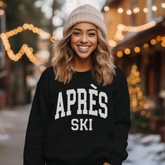 'Tis the ski-son to hit the slopes in style with our Apres Ski Sweatshirt. This trendy and cozy winter sweatshirt will keep you warm on those mountain top mornings all the way down to the crackling fire in the lodge. Our sweatshirts make great holiday gifts, especially for all the ski enthusiasts and snow lovers! Après Ski Sweatshirt, Women's trendy Sweatshirt, Ski Shirt, Ski Gifts, Gift for her, Winter Sweatshirt, Apres Ski sweater, holiday shirt A sturdy and warm sweatshirt bound to keep you w Winter Sports Sweatshirt, Casual Crew Neck Sweater For Ski Season, Sporty Sweatshirt For Winter Sports, Sporty Tops For Winter Outdoor Activities, Casual Tops For Winter Sports, Sporty Crew Neck Top For Ski Season, Casual Winter Skiing Tops, Sporty Tops For Ski Season, Sporty Top For Ski Season