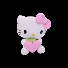 a white hello kitty stuffed animal holding a pink heart