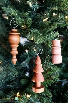 three wooden ornaments hanging from a christmas tree