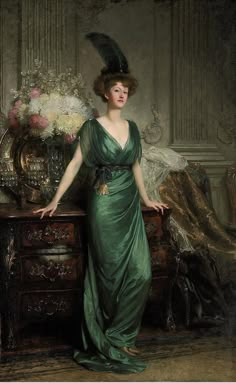 a painting of a woman in a green dress standing next to a table with flowers on it