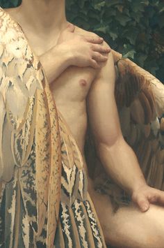 a close up of a statue of a man with an angel wings on his chest