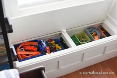 the toy storage compartment is filled with toys