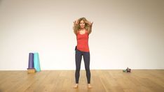 a woman standing on top of a wooden floor in front of a blue and pink object