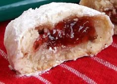 two pastries on a red and white checkered table cloth next to a green tray