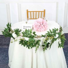 a table with flowers and greenery on it