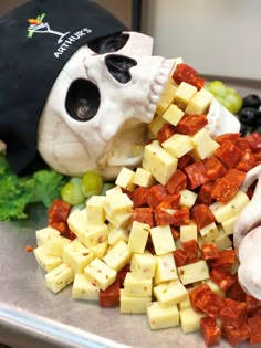 a pile of diced up food next to a skull head on top of a table