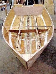 a wooden boat being built in a shop