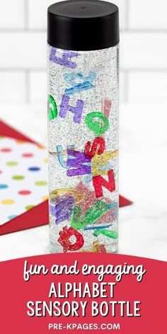 a bottle filled with alphabet letters on top of a table