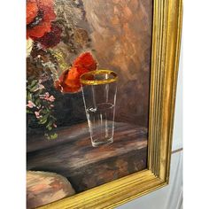 an oil painting of red flowers in a vase on a table next to a mirror