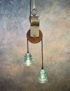 two small lights hanging from a metal hook