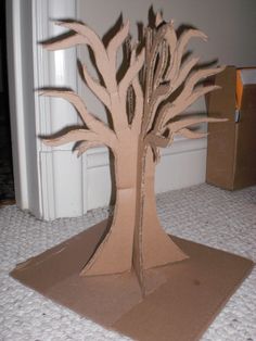 the cardboard tree is sitting on the floor