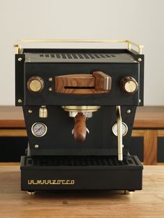 an espresso machine sitting on top of a wooden table