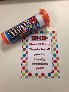 a candy bar wrapper next to a bottle of m & m's milk