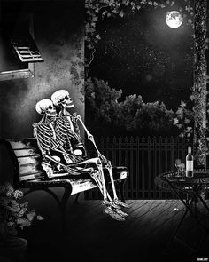 two skeletons sitting on a bench at night