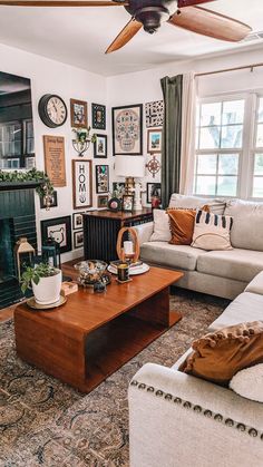 a living room filled with lots of furniture and pictures on the wall above the fireplace