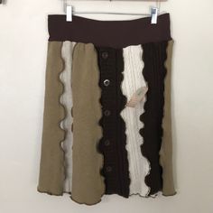 a skirt hanging on a wall with buttons