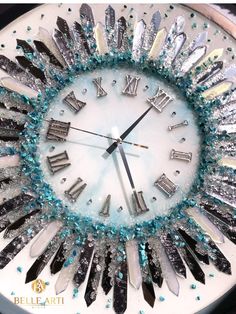 a clock made out of silver and blue beads