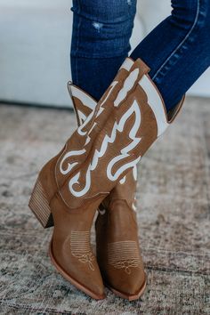 Details: Feeling Free Cowgirl Boots Contrast Embroidered Detailing Pointed Toe Slip On Thick Heel Pull on Tabs Padded Footbed Faux Leather/Suede Material Available in Camel Measurements: Shaft Height: 12" Heel Height: 3" Platform Height: 0.25" Shoe Opening Circumference: 14" We are recommending true to size for most comfort!