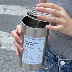 a woman holding a coffee cup in her right hand