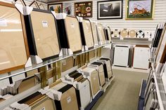 there are many framed pictures on the wall in this store, and one is for sale