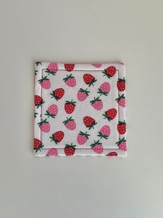 a pink and white cloth with strawberries on it