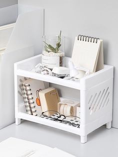 a white shelf with books and other items on it