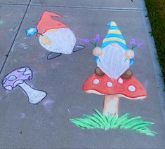 two gnomes are painted on the sidewalk with chalk