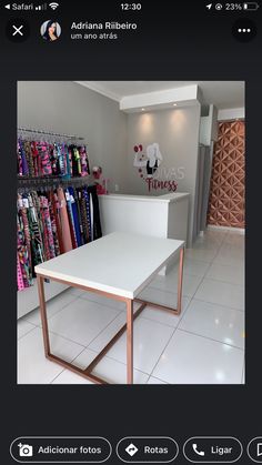 a white table sitting on top of a tile floor next to a store display case