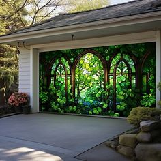 a garage with a mural on the side of it's door and trees in the background