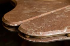 two marble tables with wooden handles on them