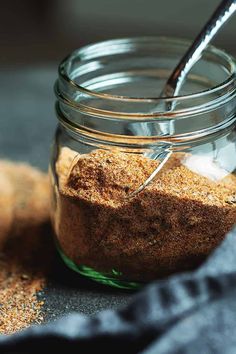 a glass jar filled with brown sugar on top of a table