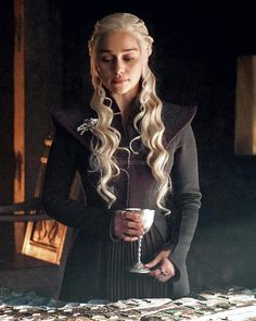 game of thrones'daeneress starke is holding a silver cup