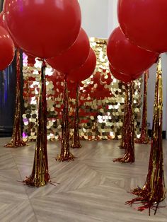 red balloons and streamers in front of gold sequins