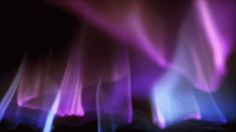 blurry image of purple and blue flames in the dark