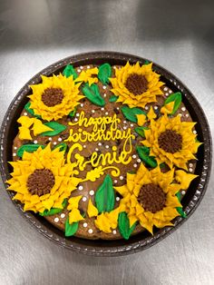 a birthday cake decorated with sunflowers and the words happy birthday gene