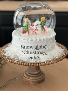 a snow globe cake with christmas decorations on top