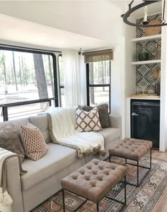 a living room filled with furniture and a fire place